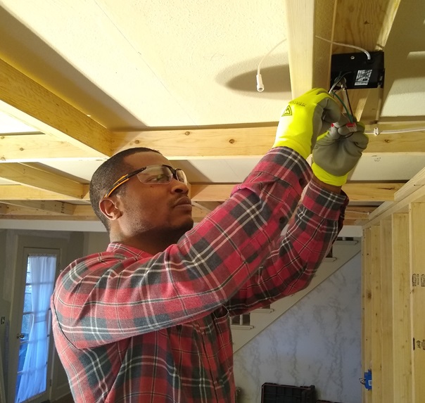 Andre from JuneCity LLC working on a ceiling electrical box